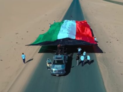 A Chevy truck pulled a 4,690 square foot Kuwaiti flag a distance of more than 328 feet to break a Guinness World Record.