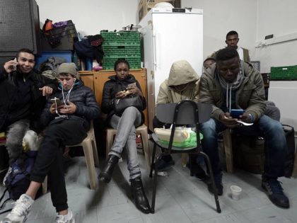 Migrants wait to spend a night at the offices of association Diakite in Bayonne, southwest