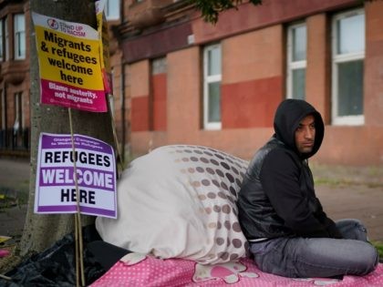 GLASGOW, SCOTLAND - AUGUST 01: Afghan refugee Rahman Sahah (L) , 32 and Mirwais Ahmadzai, 27, start their hunger strike outside the H.M. Government Home Office on August 1, 2018 in Glasgow, Scotland. Both men have been refused asylum in the UK and are currently tenants of social housing provider …