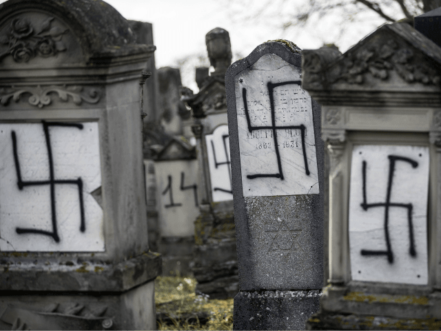 Jewish tombstones are seen desecrated with swastikas in the Herrlisheim Jewish cemetery, north of Strasbourg, eastern France, Thursday, Dec. 13, 2018. Dozens of tombs were defaced were discovered Tuesday. (AP Photo/Jean-Francois Badias)