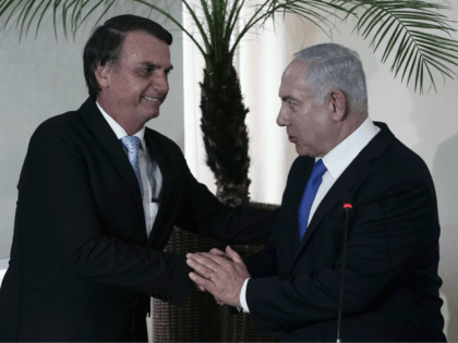 Brazil's President-elect Jair Bolsonaro, left, and Israel's Prime Minister Benjamin Netanyahu shake hands during a joint statement at the military base Fort Copacabana, in Rio de Janeiro, Brazil, Friday, Dec. 28, 2018. Despite earlier reports, Netanyahu plans to attend the inauguration of Bolsonaro on Tuesday, Jan. 1, 2019 in Brasilia. …