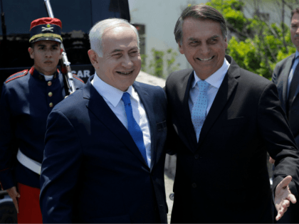 Israel's Prime Minister Benjamin Netanyahu (L) is welcomed by Brazil's President-elect Jai