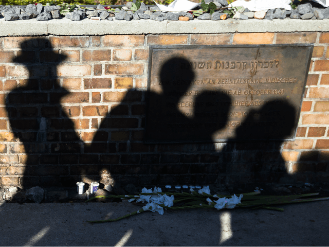 Shadow are cast on a memorial plaque at platform 17, during a ceremony to commemorate Jewi