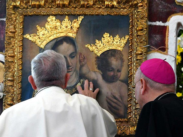 Pope Francis touches an icon of Mary and Jesus during a commemoration ceremony for the 25th anniversary of the death of Don Tonino Bello in Alessano, southern Italy on April 20, 2018. (Photo by Vincenzo PINTO / AFP) (Photo credit should read VINCENZO PINTO/AFP/Getty Images)