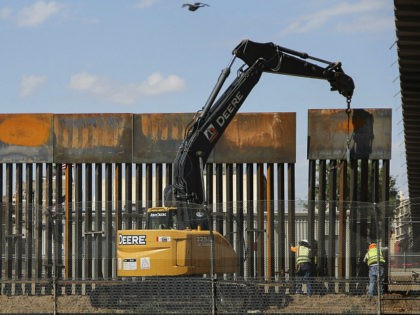 Workers in El Paso Texas, in the US, replace a section of the Mexico-US border fence next