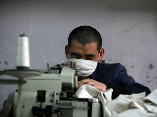 An inmate works on a sewing machine at a prison on March 7, 2008 in Chongqing Municipality