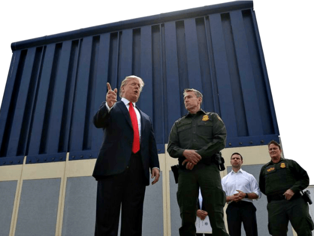 President Donald Trump speaks during a tour to review border wall prototypes, March 13, 2018, in San Diego, as Rodney Scott, the Border Patrol's San Diego sector chief, listens.