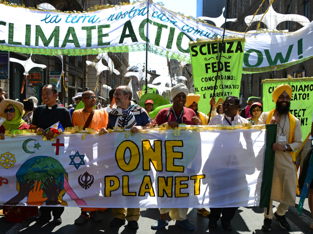 Activists display banners calling for action against world poverty, climate chanege and other environmental issues as they arrive on St. Peter's square prior to Pope Francis's Sunday Angelus prayer on June 28, 2015 at the Vatican. The activists included Christians, Muslims, Jews, Hindus and those of other denominations calling for the adoption of an ambitious legally binding global agreement on climate change at the forthcoming UN conference in Paris, December 2015, along with calls for action against world poverty and other environmental causes. AFP PHOTO / GABRIEL BOUYS (Photo credit should read GABRIEL BOUYS/AFP/Getty Images)