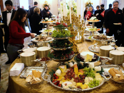 Members of the press try the food that will be served at the White House holiday parties d