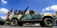 A Yemeni soldier loyal to the Shiite Huthi rebels mans a turret in the back of a pickup truck as others ride during a military parade in the capital Sanaa on October 16, 2018 to show support against the Saudi-led intervention in the country