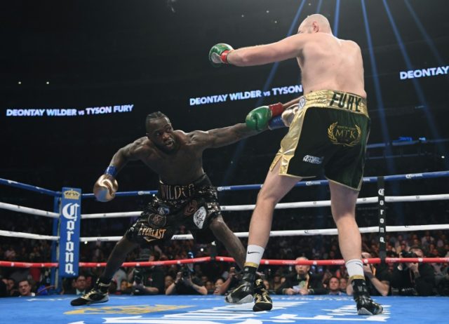 Deontay Wilder jabs Tyson Fury in the first round of their WBC Heavyweight title showdown in Los Angeles, which ended with a controversial split-decision draw Wilder, Fury battle to draw in heavyweight thriller
