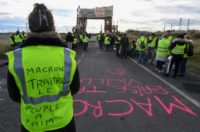 A yellow vest protester blocking a fuel depot in Frontignan, southern France, on Monday. Her vest reads "Macron traitor, the people are hungry."