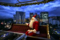 Against a backdrop of Kuala Lumpur's skyscrapers and in tropical heat, Santa in the Sky is a sleigh-like restaurant