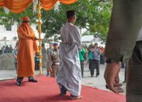 Dozens in the crowd in Indonesia's conservative Muslim province of Aceh jeered and called for the men to be whipped harder