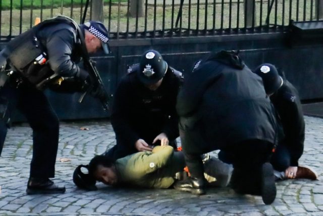 Armed police detain man outside British parliament