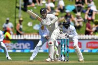 New Zealand's captain Kane Williamson (C) plays a shot with Sri Lanka's keeper Niroshan Dickwella (R) during day two of the first Test cricket match between New Zealand and Sri Lanka at the Basin Reserve in Wellington on December 16, 2018.