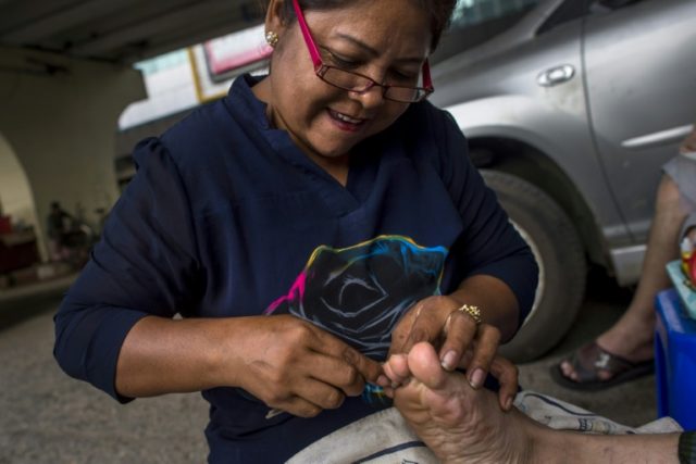 Ear cleaners, roadside clerks: antiquated jobs thrive in Yangon