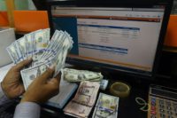 A Pakistani dealer counts US dollars at a currency exchange shop in Karachi on November 30, 2018