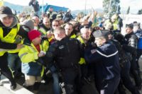 Police officers repel "yellow vest" protesters as they demonstrate against the rising cost of living at the A9 highway toll at Le Boulou, southern France