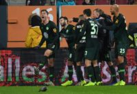 Midfielder Yannick Gerhardt (L) celebrates with his Wolfsburg teammates after his late goal sealed a thrilling 3-2 win at Augsburg to leave them fifth in the Bundesliga and four points from the Champions League places.