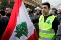 A Lebanese protester wears a yellow vest, inspired by France's Gilet Jaunes, during an anti-corruption demonstration in Beirut on December 23, 2018 Hundreds take to Beirut streets over corruption