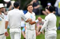 New Zealand's Trent Boult (centre) is congratulated by teammates Tim Southee (left) and Henry Nicholls after competing his six-wicket burst