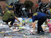 Scattered debris including items traditionally sold for New Year celebrations, such as cardboard and plastic horns and gifts, as well as a bloody slipper, lay at the mall's entrance where the explosion took place