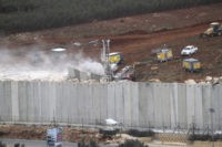 Israel Hezbollah An Israeli military digger works on the Lebanese Israeli border next to a wall that was built by Israel in the southern village of Kafr Kila, Lebanon, Tuesday, Dec. 4, 2018. The Israeli military launched an operation on Tuesday to "expose and thwart" tunnels it says were built by the Hezbollah militant group that stretch from Lebanon into northern Israel. (AP Photo/Mohammed Zaatari) Israeli operation targets Hezbollah cross-border tunnels