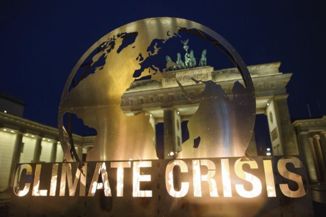 Germany Climate Greenpeace A metal sculpture sits in front of the Brandenburg Gate in Berlin Tuesday, Dec. 11, 2018 as Greenpeace activists protest against Germany's strategy against global warming. (Gregor Fischer/dpa via AP) The Associated Press