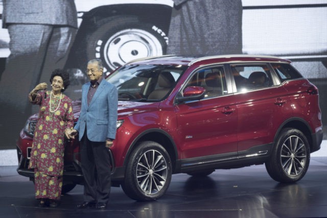 Malaysia Proton Mahathir Mahathir Mohamad, Siti Hasmah Malaysia Prime Minister Mahathir Mohamad, right, poses with his wife Siti Hasmah during the launch of Proton new SUV in Kuala Lumpur, Malaysia, Wednesday, Dec. 12, 2018. Malaysian national car maker Proton launches the X70, its first sports utility vehicle. Loss making Proton, which is 49.9 percent owned by China's Geely Holding Group Co. Ltd., is hoping that the sleek SUV will help to turnaround its fortune. The X70 is based on Geely's Boyue, that was launched two years ago and is one of China's best selling SUV. (AP Photo/Vincent Thian) The Associated Press