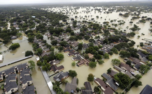 Texas Climate Change Addicks Reservoir In this Aug. 29, 2017, file photo, water from Addicks Reservoir flows into neighborhoods from floodwaters brought on by Tropical Storm Harvey in Houston. Natural disasters in Texas on the scale of Hurricane Harvey’s deadly destruction last year will become more frequent because of a changing climate, warns a new report Thursday, Dec. 13, 2018, ordered by Republican Gov. Greg Abbott in a state where skepticism about climate change runs deep. (AP Photo/David J. Phillip, File) The Associated Press