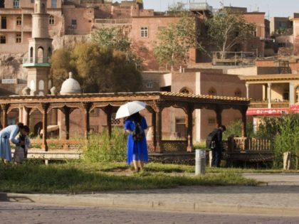 China Arrested Photographer In this Aug. 31, 2018, file photo, visitors walk past the old city district in Kashgar, western China's Xinjiang region. Police have confirmed that a prominent Chinese photographer who went missing more than a month ago was arrested, his wife said.Authorities informed relatives of award winning photographer Lu Guang, whose work focuses unsparingly on the harshest realities of life in China, that he was arrested in Kashgar city in the country's far west region of Xinjiang, his wife Xu Xiaoli told The Associated Press on Thursday, Dec. 13, 2018.(AP Photo/Ng Han Guan, File) In this Aug. 31, 2018, file photo, visitors walk past the old city district in Kashgar, western China's Xinjiang region. Police have confirmed that a prominent Chinese photographer who went missing more than a month ago was arrested, his wife said.