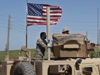 Syria In this April 4, 2018 photo, a U.S backed Syrian Manbij Military Council soldier, left, speaks with a U.S. soldier, at a U.S. position near the tense front line with Turkish backed fighters, in Manbij town, north Syria. President Donald Trump's decision to withdraw troops from Syria has rattled Washington's Kurdish allies, who are its most reliable partner in Syria and among the most effective ground forces battling the Islamic State group. Kurds in northern Syria said commanders and fighters met into the night, discussing their response to the surprise announcement Wednesday, Dec. 20, 2018. (AP Photo/Hussein Malla) The Associated Press