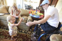 Crowdsourcing Border Wall FILE In this AprIl 1, 2015, file photo, retired Air Force Airman Brian Kolfage, right, gives a piece of cheese to his one year old daughter Paris Kolfage as his wife Ashley Kolfage looks on at their recently rented home in Sandestin, Fla. Kolfage, a triple amputee who lost his limbs serving in Iraq in the U.S. Air Force, started a GoFundMe page to help fund construction of President Donald Trump's border wall has already raised millions of dollars.(Nick Tomecek/Northwest Florida Daily News via AP, file) The Associated Press