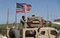 Syria In this April 4, 2018 photo, a U.S backed Syrian Manbij Military Council soldier, left, speaks with a U.S. soldier, at a U.S. position near the tense front line with Turkish backed fighters, in Manbij town, north Syria. President Donald Trump's decision to withdraw troops from Syria has rattled Washington's Kurdish allies, who are its most reliable partner in Syria and among the most effective ground forces battling the Islamic State group. Kurds in northern Syria said commanders and fighters met into the night, discussing their response to the surprise announcement Wednesday, Dec. 20, 2018. (AP Photo/Hussein Malla) The Associated Press