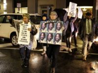 Protestors walk on Broad Street to demonstrate for Mumia Abu-Jamal outside the offices of District Attorney Larry Krasner, Friday, Dec. 28, 2018, in Philadelphia. A judge issued a split ruling Thursday that grants Abu-Jamal another chance to appeal his 1981 conviction in a Philadelphia police officer's death. (AP Photo/Matt Slocum)