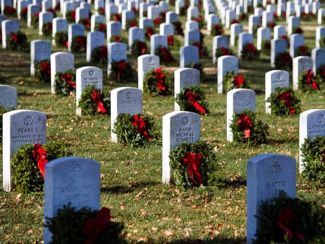 Wreaths grace headstones at Arlington National Cemetery as Wreaths Across America places remembrance wreaths on the nearly 245,000 headstones at the cemetery in Arlington, Va., Saturday, Dec. 16, 2017. (AP Photo/Cliff Owen)