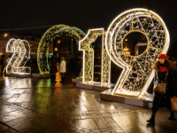 2019 A woman walks in front of an illuminated '2019' sign on a square in central Moscow on December 30, 2018, ahead of the new year. (Photo by Mladen ANTONOV / AFP) (Photo credit should read MLADEN ANTONOV/AFP/Getty Images)
