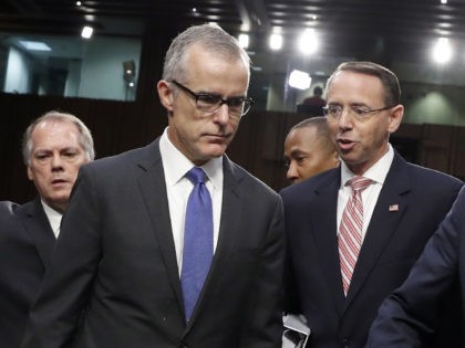 Jim Wolfe, committee staff member, helps direct FBI acting director Andrew McCabe, left, Deputy Attorney General Rod Rosenstein, and Director of National Intelligence Dan Coats to their seats for a Senate Intelligence Committee hearing about the Foreign Intelligence Surveillance Act, on Capitol Hill, Wednesday, June 7, 2017, in Washington. (AP …