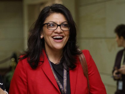 Rep.-elect Rashida Tlaib, D-Mich., right, walks with a reporter to a session during member-elect briefings and orientation on Capitol Hill in Washington, Thursday, Nov. 15, 2018. (AP Photo/Carolyn Kaster)
