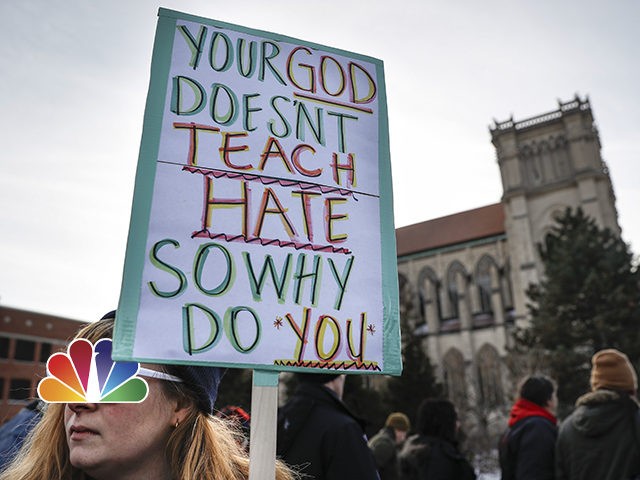 (INSET: NBC News logo) Protestors gather outside the Catholic Diocese of Covington Tuesday, Jan. 22, 2019, in Covington, Ky. The diocese in Kentucky has apologized after videos emerged showing students from Covington Catholic High School mocking Native Americans outside the Lincoln Memorial on Friday after a rally in Washington. (AP …