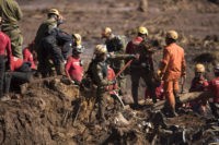 An Israeli rescue specialist, center, works with fellow rescue workers on a site where a body was found inside a vehicle stuck in the mud, days after a dam collapse in Brumadinho, Brazil, Monday, Jan. 28, 2019. Firefighters on Monday carefully moved over treacherous mud, sometimes walking, sometimes crawling, in …