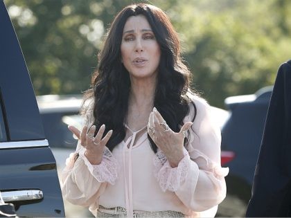 Singer and actress Cher stops to talk to media as she leaves a fundraiser for Democratic p