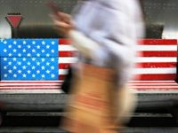 China Trade Talks In this Sunday, Jan. 6, 2019, photo, a woman walks by a bench painted with the U.S. flag at the capital city's popular shopping mall in Beijing. A U.S. delegation led by deputy U.S. trade representative, Jeffrey D. Gerrish arrived in the Chinese capital for a trade talks with China. …