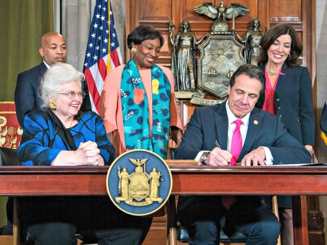 In this photo provided by the Office of Gov. Andrew M. Cuomo, Cuomo, right, signs Reproduc