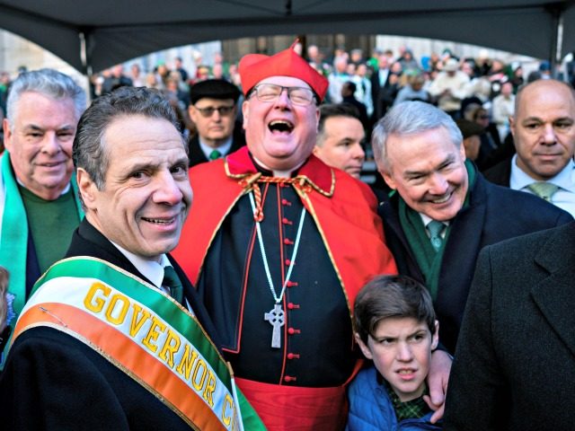 Cardinal Timothy Dolan, center, laughs as he joined by Democratic Gov. Andrew Cuomo, center left, and Rep. Peter King, R-N.Y., background left, in front of St. Patrick's Cathedral during the St. Patrick's Day parade Saturday, March 17, 2018, in New York.