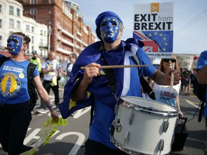 Protesters march along the seafront wearing European flag masks in Brighton on September 24, 2017, on a march against Brexit. Britain's revitalised Labour opposition kicks off its annual conference today with leader Jeremy Corbyn set to lay out his party's agenda, free from the leadership challenges of previous years. / …