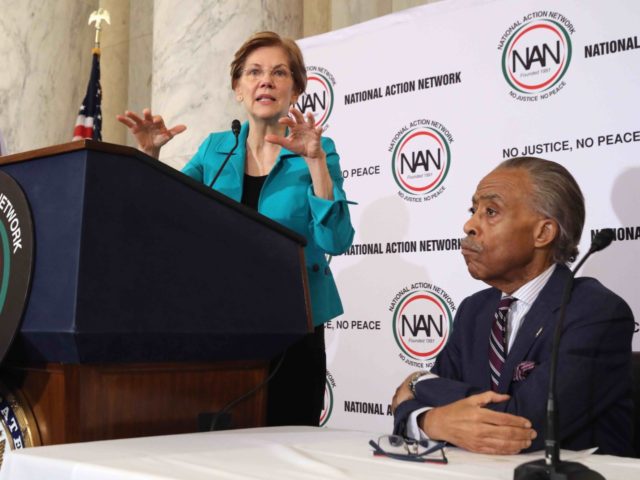 WASHINGTON, DC - NOVEMBER 13: The Rev. Al Sharpton (R) listens to Sen. Elizabeth Warren (D-MA) as she addresses Sharpton's National Action Network during a post-midterm election meeting in the Kennedy Caucus Room at the Russell Senate Office Building on Capitol Hill November 13, 2018 in Washington, DC. Politicians believed …