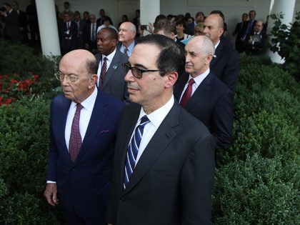 WASHINGTON, DC - JULY 25: Members of U.S. President Donald Trump's cabinet, including Treasury Secretary Steve Mnuchin (R) and Commerce Secretary Wilbur Ross (L) listen as Trump and European Commission President Jean-Claude Juncker deliver a joint statement in the Rose Garden of the White House to deliver a joint statement …