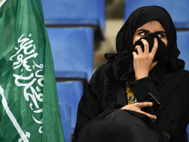 Saudi women cheer for their football team during a friendly match between Saudi Arabia and